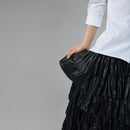BLACK RUFFLED SKIRT IN FAUX LEATHER FABRIC